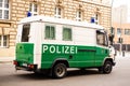 white and green police bus parked on street in Berlin, symbol law and order, emergency response, international cooperation in