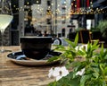 white green summer flowers street restaurant black cup of cofee glass of wine and candle light on table top  night street medieva Royalty Free Stock Photo