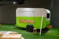 White and green trailer food truck on artificial lawn