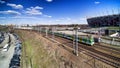 White and green train passing through next to National Stadium in Warsaw. Royalty Free Stock Photo