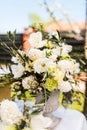 White and green variety of flowers in a large central table bouquet