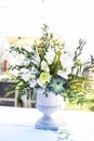 White and green variety of flowers in a large central table bouquet