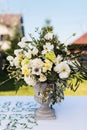 White and green variety of flowers in a large central table bouquet