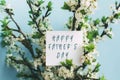 greeting card Happy Father`s Day in spring bouquet of flowering trees on blue background Royalty Free Stock Photo