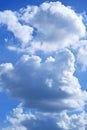White and grey cumulus clouds on blue sunny sky Royalty Free Stock Photo