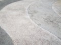 White and grey curved cement sidewalk or ground