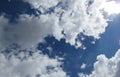 White and grey fluffy clouds in a sunny blue sky Royalty Free Stock Photo