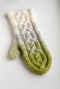 White, grey and green knitted mitten Royalty Free Stock Photo