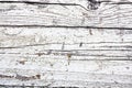 White and greyish painted cracked and peeling wooden wall board as texture background