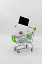 White guitar pedal and green shopping cart on white