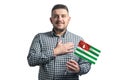 White guy holding a flag of Abkhazia and holds his hand on his heart isolated on a white background With love to
