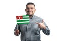 White guy holding a flag of Abkhazia and points the finger of the other hand at the flag isolated on a white background