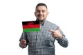 White guy holding a flag of Malawi and points the finger of the other hand at the flag isolated on a white background Royalty Free Stock Photo