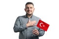 White guy holding a flag of Turkey and holds his hand on his heart isolated on a white background With love to Turkey Royalty Free Stock Photo