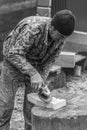 White guy joiner carpenter handles grinder wooden detail