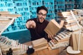 White guy surrounded by books in library. Student is emotionally reading book. Royalty Free Stock Photo