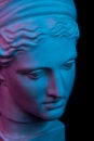 Gypsum copy of ancient statue Diana head isolated on black background. Plaster sculpture woman face.
