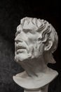 Gypsum copy of ancient statue Seneca head on dark textured background. Plaster sculpture man face. Royalty Free Stock Photo