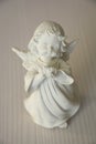 White gypsum figurine angel on a light background Royalty Free Stock Photo