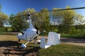 White gyroplane parked on the private airfield