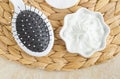 White hair mask (face cream, hair treatment, body butter) with algae extract and hairbrush. Natural hair treatment Royalty Free Stock Photo