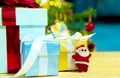 white hair  Santa Claus and christmas gift box with red ribbon on christmas tree and abstract bokeh glitter background Royalty Free Stock Photo