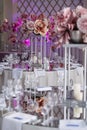 in the white hall of restaurant there are tables with festive decor for a wedding celebration, decoration of the hall with Royalty Free Stock Photo