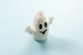 White Halloween ghost on a blue background. Minimal holiday concept