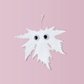 White Halloween leaf with funny eyes on pink background. Funny minimal concept