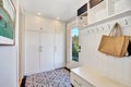 White hallway interior. Storage cabinet with hangers