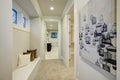 White hallway space with built-in seat topped with pillows