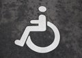 White Handicap Disabled Sign on Black Asphalt Royalty Free Stock Photo