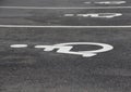 White Handicap Disabled Sign on Black Asphalt Royalty Free Stock Photo