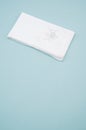 White handkerchief with a flower on it on a light blue background