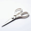 White-handled scissors on a clean, white surface. The blades appear metallic and Royalty Free Stock Photo