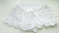 Delicate summer shorts for ladies. Woman's white lace shorts. Lace shorts on white showcase. White handmade shorts