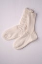 White handmade warm knitted wool socks pair for cold winter Royalty Free Stock Photo