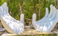 White hands sculpture figure in tropical jungle near cenote Mexico