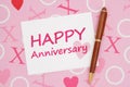 White Happy Anniversary greeting card on pink love paper Royalty Free Stock Photo