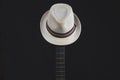 White hat hangs on the guitar fretboard. acoustic musical instrument. strings on the guitar neck Royalty Free Stock Photo