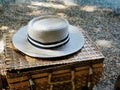 White and black hat placed on a brown woven bamboo basket