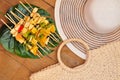 White hat set of fruit barbecue and straw purse on wooden pier. Summer picnic Royalty Free Stock Photo