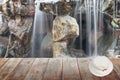 White hat on wooden floor and Waterfall flowing
