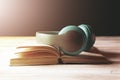 White headphones on the book and a magnifier Royalty Free Stock Photo