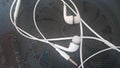 White headphones with headset lying on black background Royalty Free Stock Photo