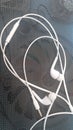 White headphones with headset lying on black background