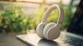 The white headphones on the laptop with a serene natural background. AI generated image Royalty Free Stock Photo