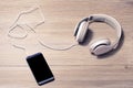 White headphones and mobile phone on a table music listen lover earphones hobby free time rest relax pause leisure break meloman t Royalty Free Stock Photo