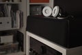 White headphones over central speakers from a 7.1 THX Hi-Fi sound system