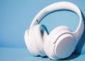 White headphones, pastel blue background, copyspace for text - blank space, music concept, digital ai